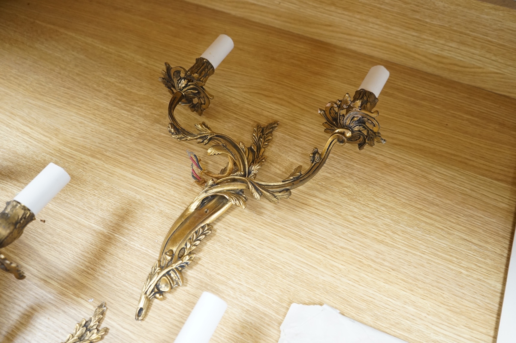 A pair of gilt metal two branch wall sconces, 37cm